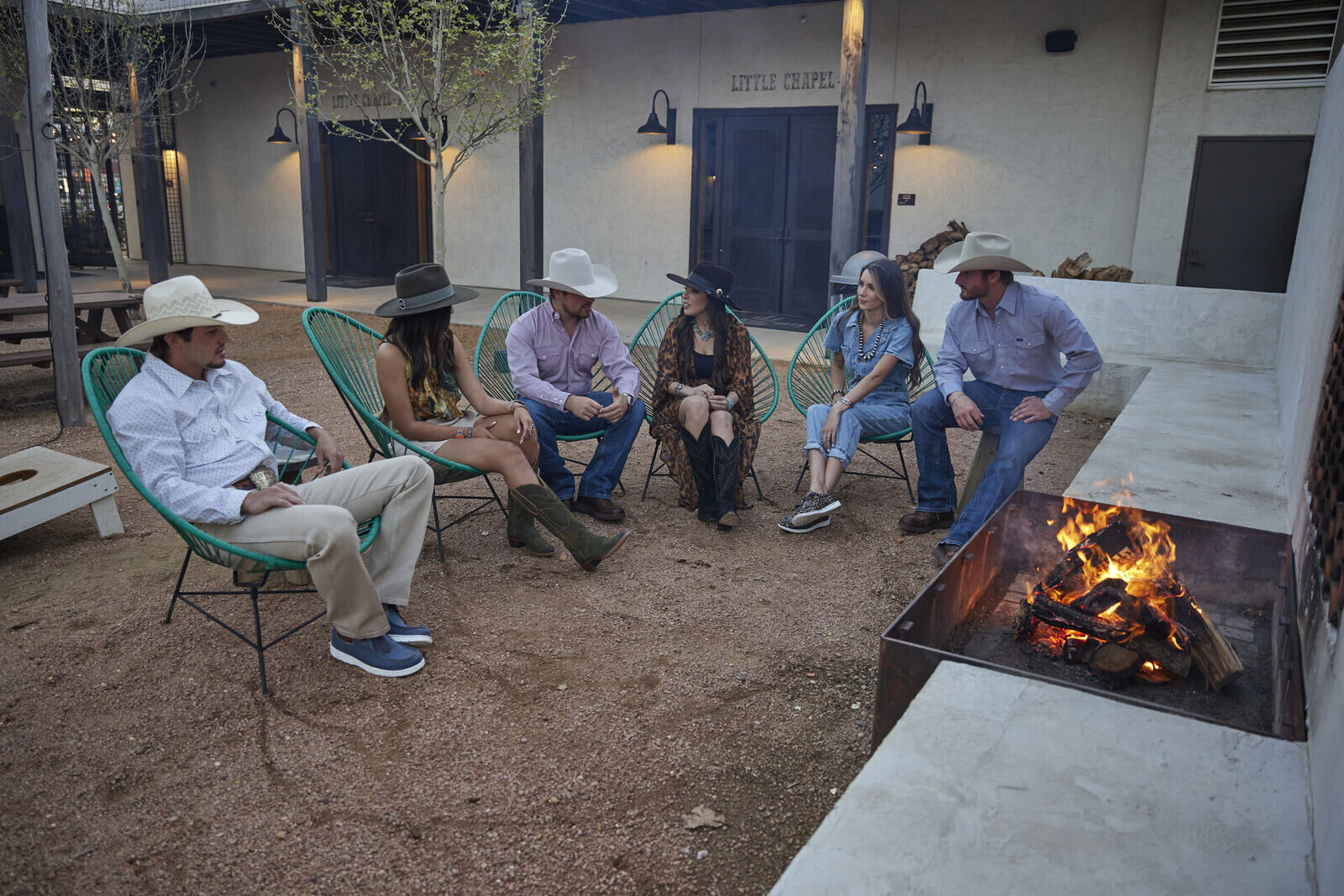 group sitting around fire